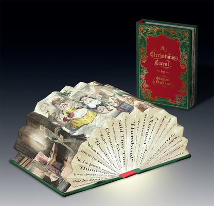 A Christmas Carol light book, open and lit beside the closed book